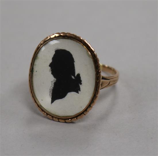 A Georgian style yellow metal oval silhouette ring, decorated with the bust of a gentleman to dexter, size S.